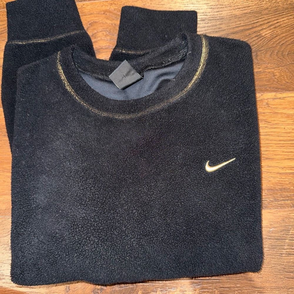 Nike Dri-Fit fleece cropped sweater in black with gold accents